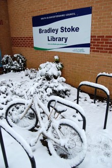 Bike in the snow outside Bradley Stoke Library.