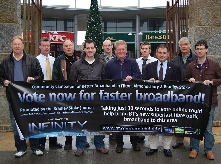 Photo of a group of people holding a banner displaying the headline, "Vote now for faster broadband".