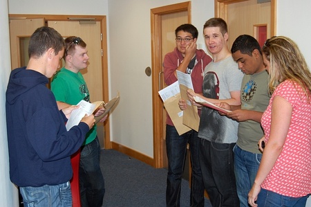 BSCS A-level students open their envelopes and compare results.
