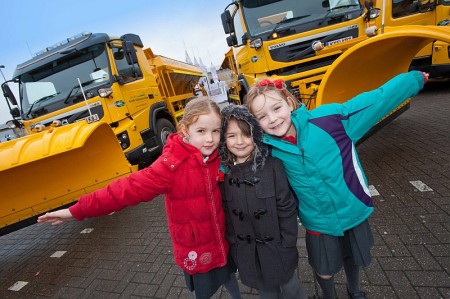 Pupils from Baileys Court Primary School with council gritting vehicles.