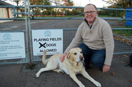 Tom Adkins and Charlie the labrador celebrate the Town Council's decision.