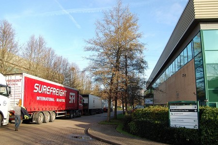 Lorries wait in line outside the Greencore food processing plant.