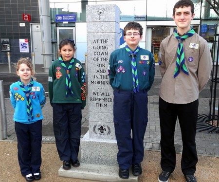 Scout group members beside the newly-installed war memorial in the town square.
