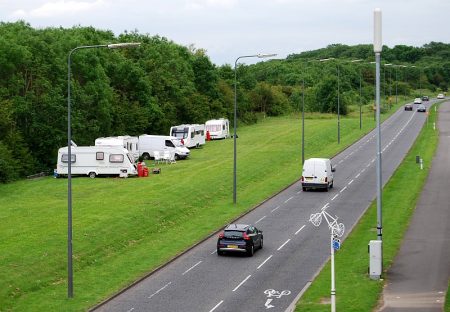 Traveller vehicles park on a verge alongside Bradley Stoke Way.