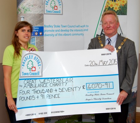 Community fundraising organiser Ella Mayne of GWAAC receives a charity collection cheque from Cllr John Ashe, mayor of Bradley Stoke.