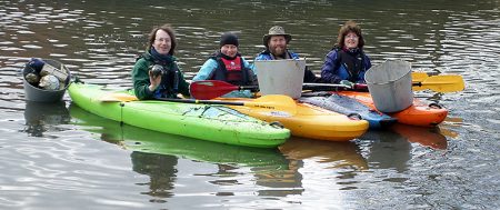 Kayakers clear litter from the lake in the Three Brooks Local Nature Reserve, Bradley Stoke.