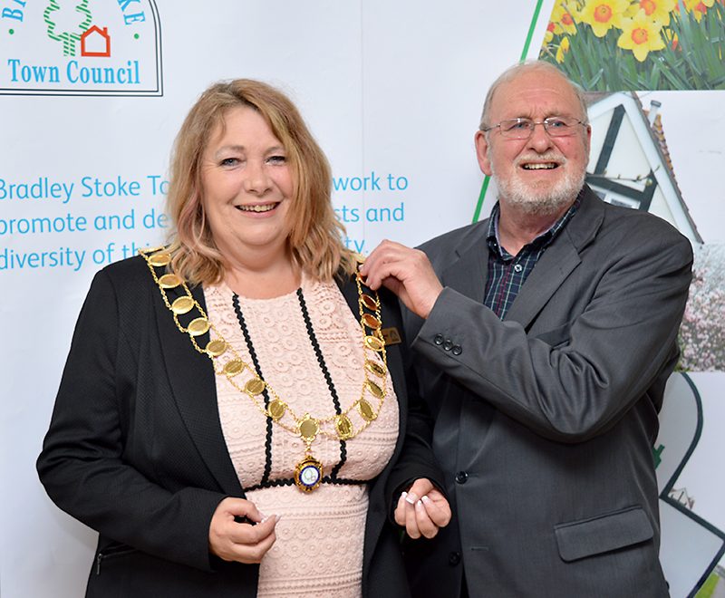 Newly-elected Mayor of Bradley Stoke Cllr Elaine Hardwick (left) receives the chain of office from previous mayor Cllr Roger Avenin.