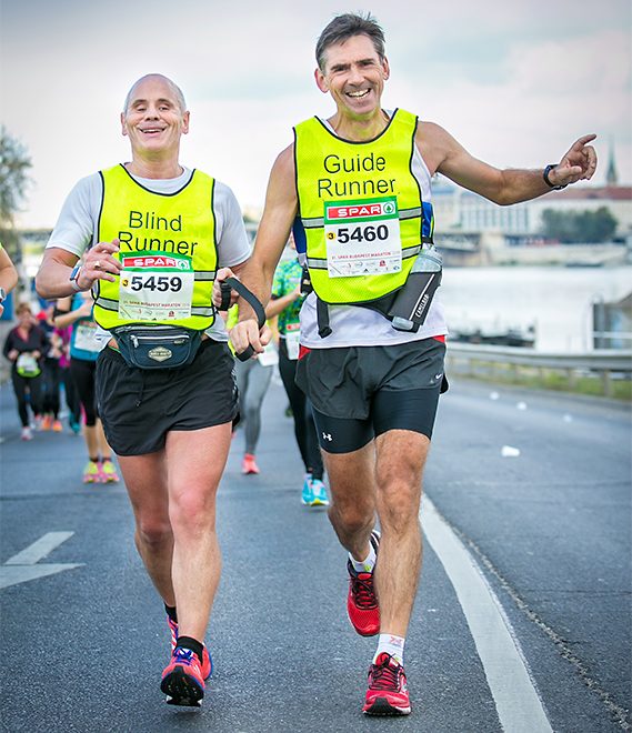 Blind runner Chris Blackabee competing in the 2016 Budapest Marathon with his guide Colin Johnson.