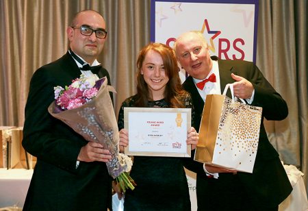 Photo of Kyra Morley receiving her award.