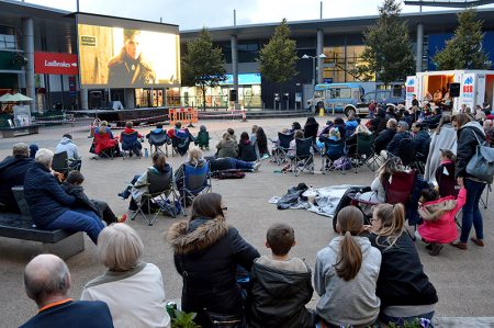 Photo of crowd and screen at the 'Movies in the Square' event.