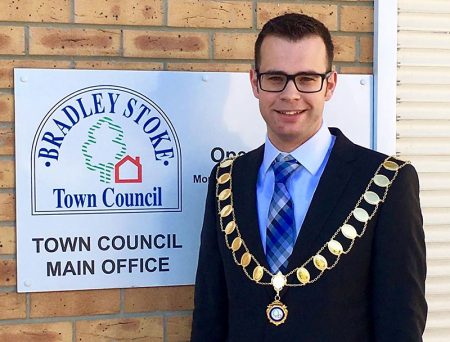 Photo of Cllr Ben Randles wearing the mayoral chain and standing outside the council offices.