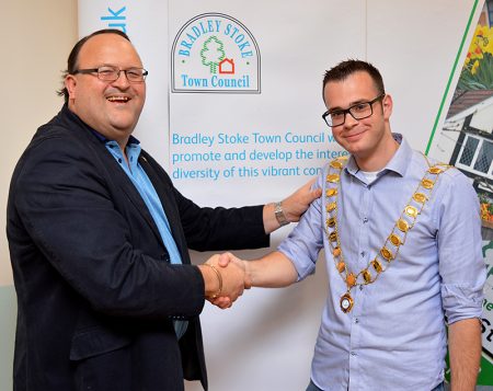 Photo of Cllr Ben Randles (right) being congratulated by the previous office holder, Cllr Andy Ward.