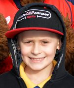 Photo of Bailey Cooper wearing a Let's CAP Cancer cap.