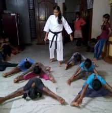 Photo of Khushi Ashwin teaching self-defence karate to a group of young girls at a shelter home in India.