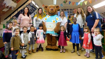 Photo of staff and children at the Mama Bear's Day Nursery setting at Baileys Court.