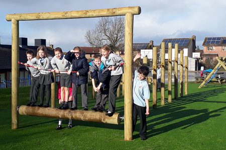 Photo of children standing on play equipment at St Michael's Primary School.