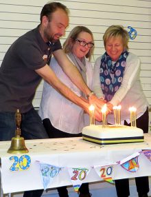 Photo of current headteacher Phil Winterburn and former heads Lois Haydon and Chris Dursley cutting an anniversary cake.