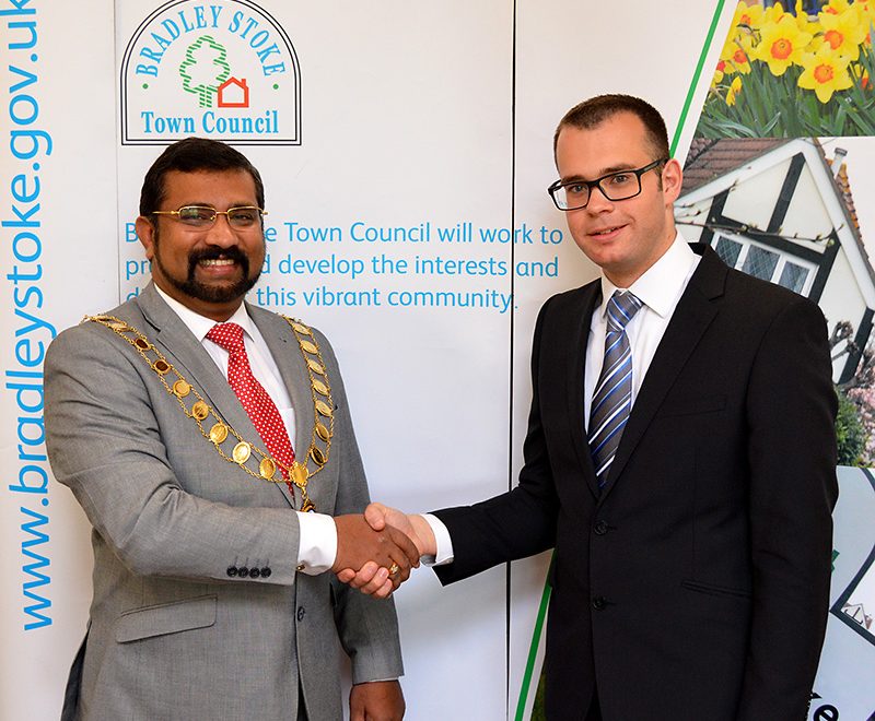 Photo of Cllr Tom Aditya (left) being congratulated by the previous office holder, Cllr Ben Randles.