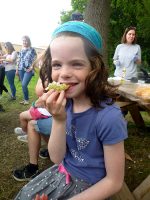 Photo of a girl enjoying the fruits of the foraging walk.