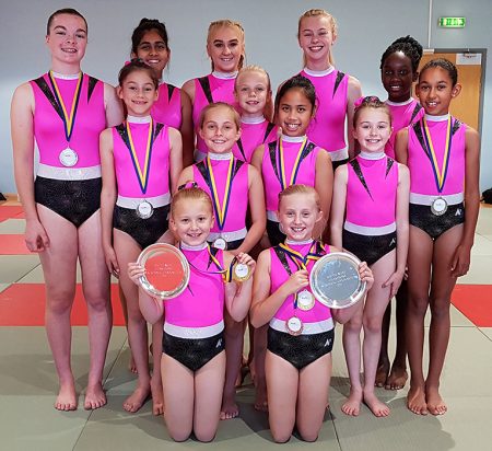 Photo of club members with medals and trophies won at the 2019 South West Championships.