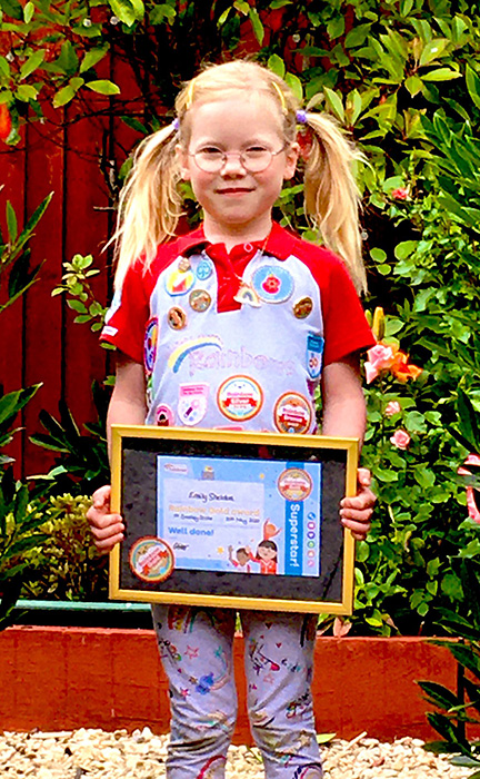 Photo of Emily with her Rainbow Gold Award.