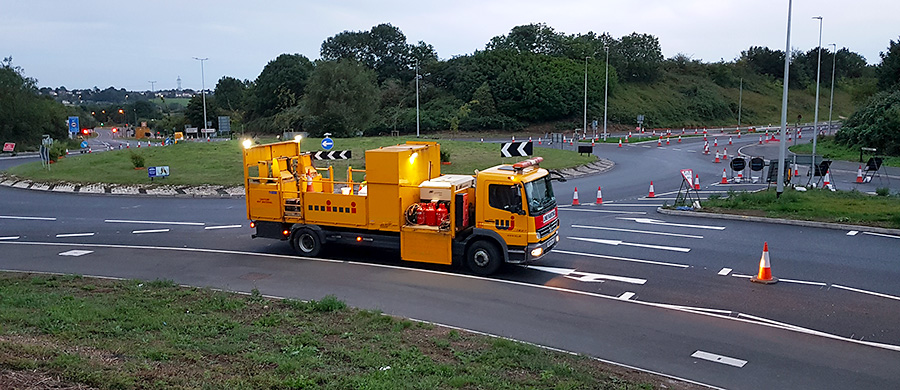 Photo of road marking (white lining) of the new surface taking place.