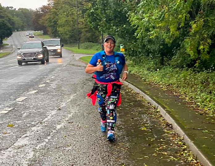 Photo of Claire running up Alveston Hill.