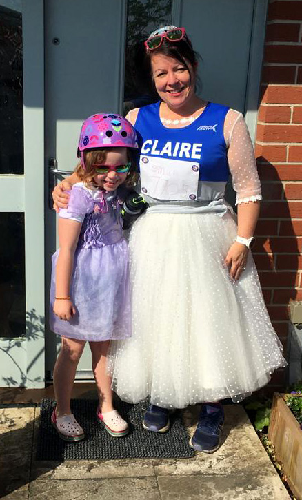 Photo of Claire in her wedding dress with Ella.