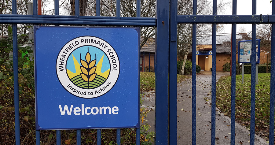 Photo of a closed entrance gate at Wheatfield Primary School.