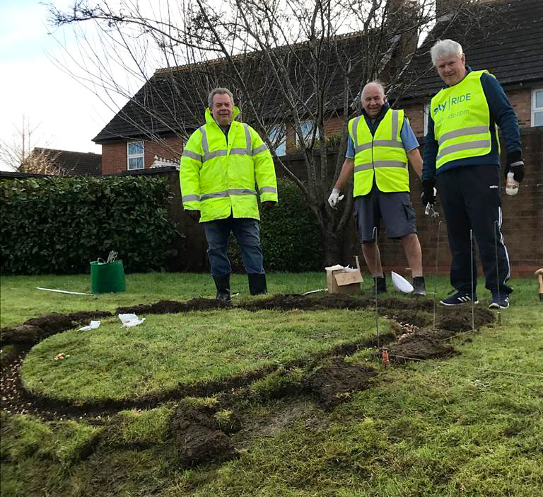 Photo showing members of Bradley Stoke Rotary Club plant crocus bulbs.