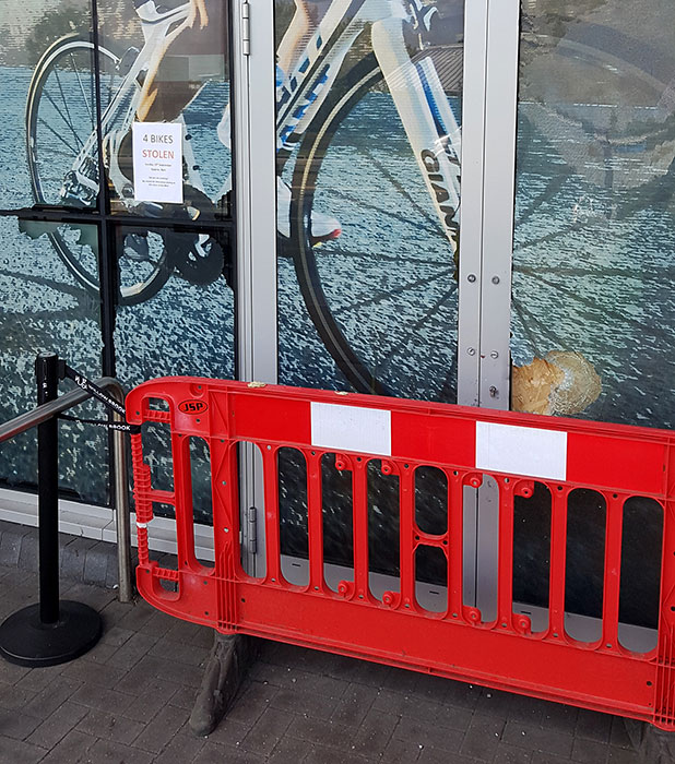 Photo of a smashed glass pane in a door.