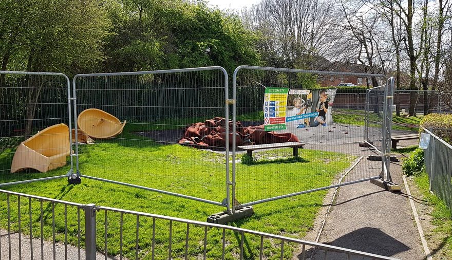 Photo of a dismantle play area behind security fencing.