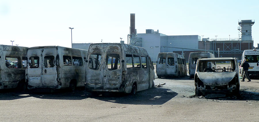 Photo showing a number of burnt-out minibuses.