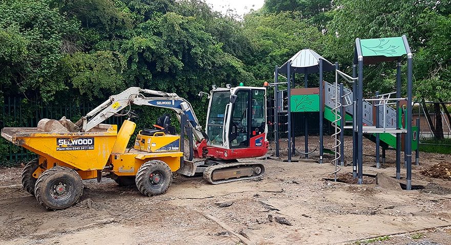 Photo of two excavators in a children's play area.