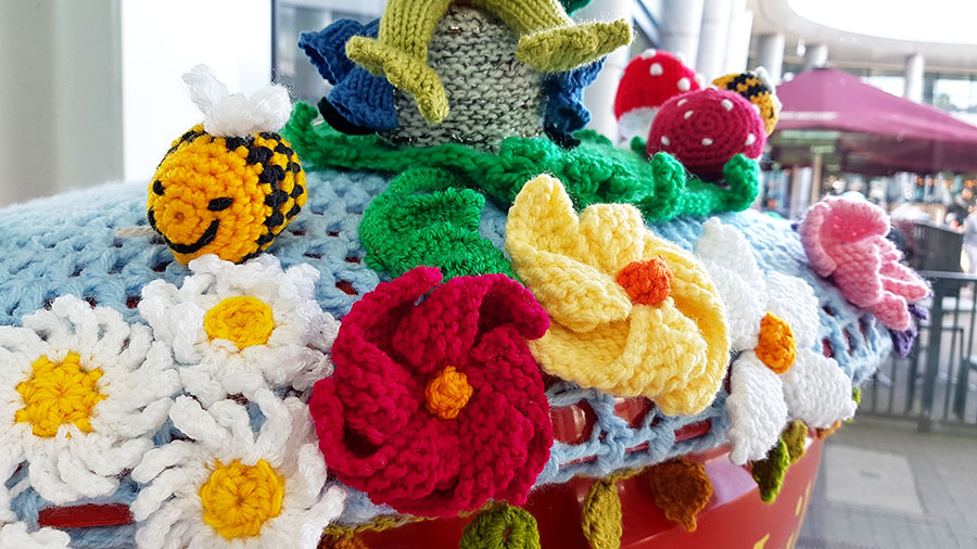 Photo of detail in a crocheted display on top of a Royal Mail postbox.