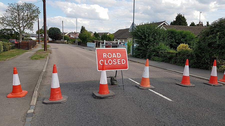 Photo of a 'road closed' sign and traffic cones.