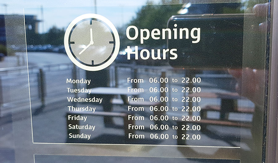 Sign displaying opening hours.