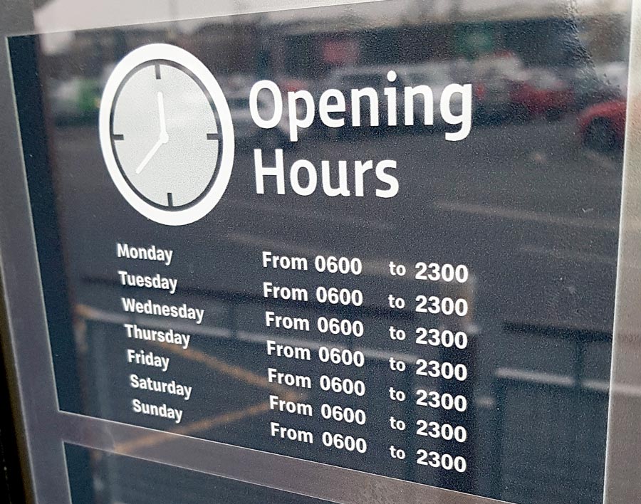 Photo of a sign displaying opening hours.