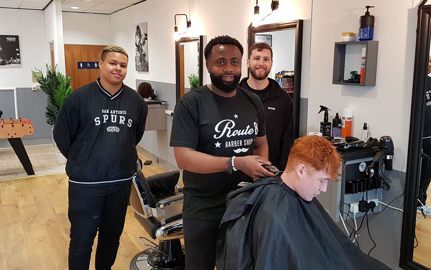Photo of a number of staff in a barber shop.