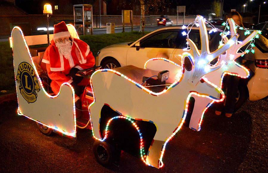 Photo of Santa sitting on a motorised sleigh.