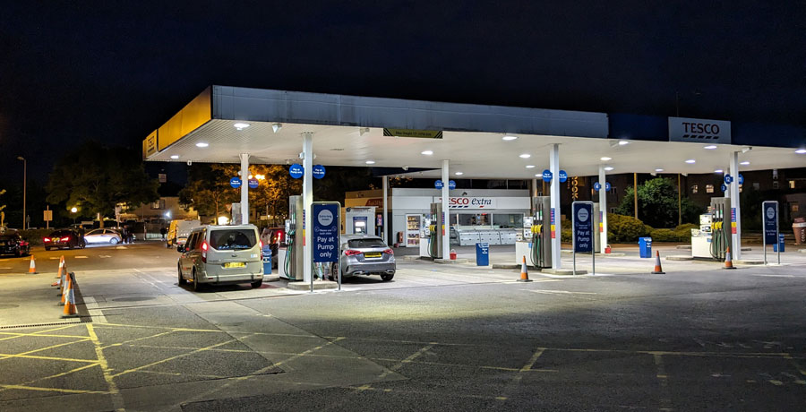 Photo of a Tesco petrol filling station at night.