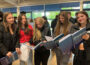 Photo of a group of students holding yearbooks.