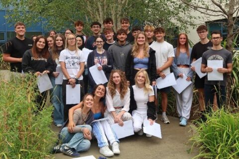 Photo of a group of students holding envelopes.