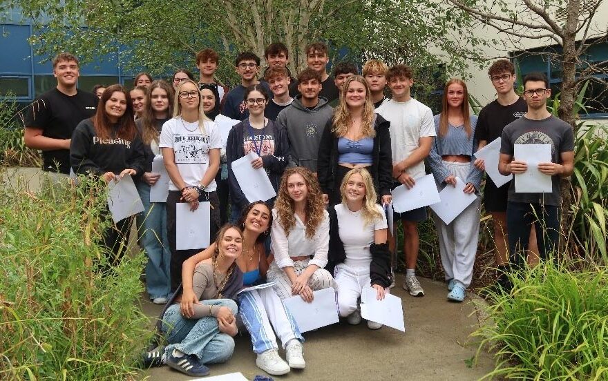 Photo of a group of students holding envelopes.