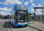 Photo of a bus waiting at a stop.