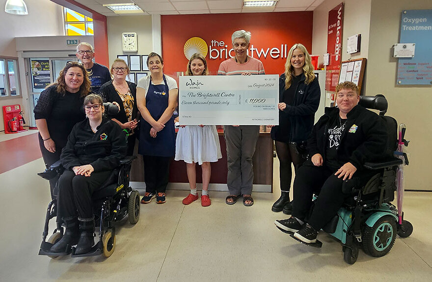 Photo of a charity cheque presentation.